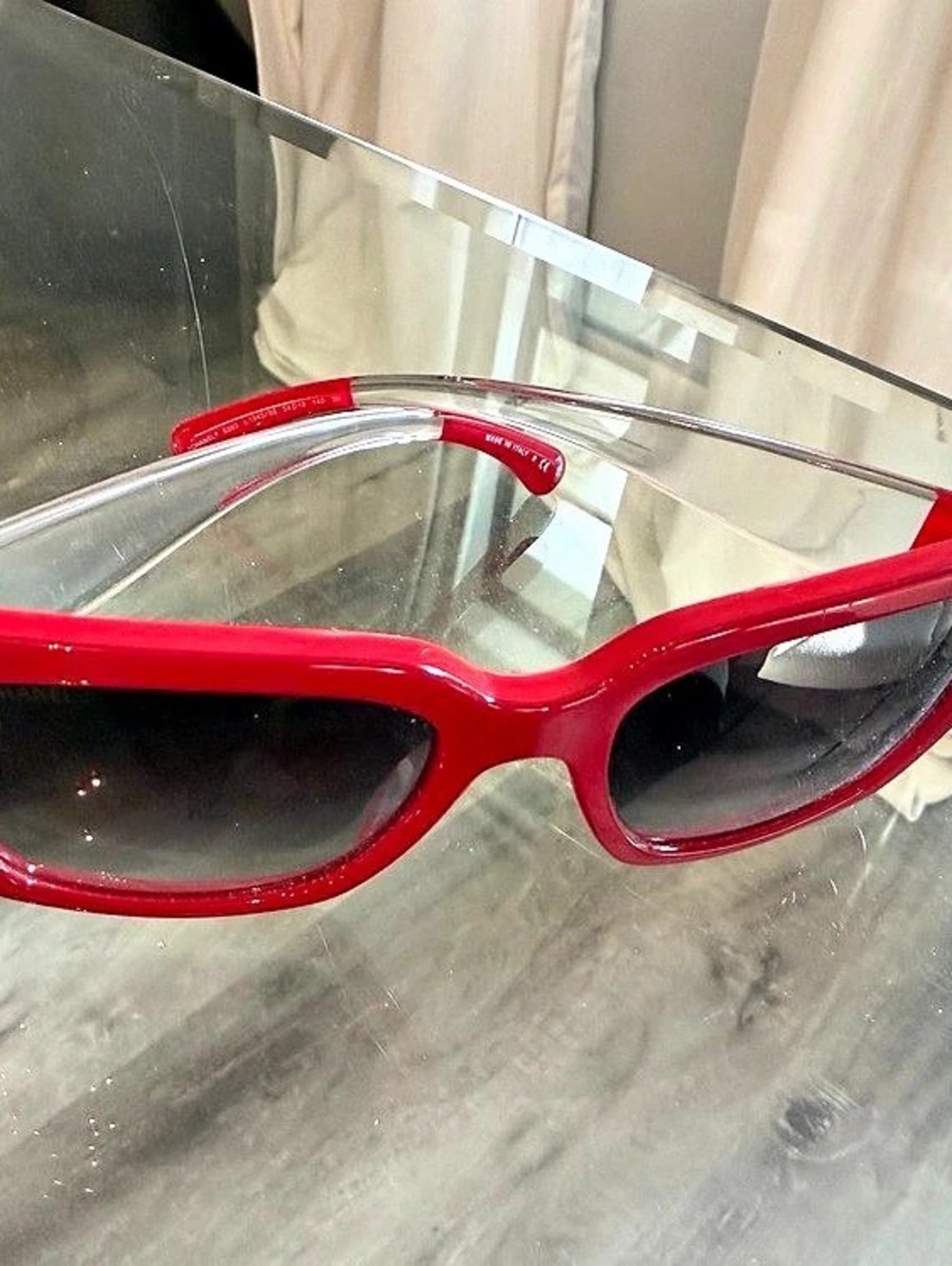 Bright red Chanel sunglasses with transparent Temples